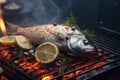 Fresh raw fish with lemon and rosemary on the flaming grill.