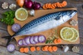 Fresh raw fish mackerel and ingredients for cooking on a wooden background Royalty Free Stock Photo