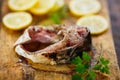 Fresh raw tasty morsel of fish with lemon slices and parsley on wooden Board Royalty Free Stock Photo