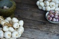 Fresh raw garlic bundle on cutting board, traditional mortar, copy space, kitchen raw ingredient concept