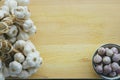 Fresh raw garlic bundle on cutting board, traditional mortar, copy space, kitchen raw ingredient concept