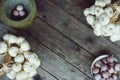 Fresh raw garlic bundle on cutting board, traditional mortar, copy space, kitchen raw ingredient concept