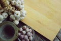Fresh raw garlic bundle on cutting board, traditional mortar, copy space, kitchen raw ingredient concept