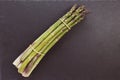 Fresh raw green asparagus spears on black background, copy space Royalty Free Stock Photo