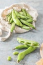 Fresh and raw green broad beans on kitchen table Royalty Free Stock Photo