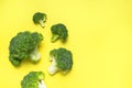 Fresh raw green broccoli on yellow background. Healthy vegetables, diet vegan organic food, vitamins. Creative food Royalty Free Stock Photo