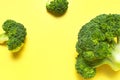 Fresh raw green broccoli on yellow background. Healthy vegetables, diet vegan organic food, vitamins. Creative food Royalty Free Stock Photo