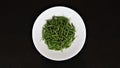 Fresh raw green hot bird eye chilies in white plate