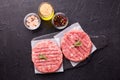 Fresh raw hamburger patties or cutlet on brown board Royalty Free Stock Photo