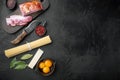 Fresh raw ingredients for traditional italian pasta Carbonara, on black stone background, top view flat lay, with copy space for Royalty Free Stock Photo