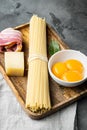 Fresh raw ingredients for traditional italian pasta Carbonara, on gray stone background Royalty Free Stock Photo