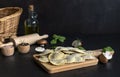 Fresh raw italian filled pasta ravioli or tortelli with mushrooms, pesto, and ricotta