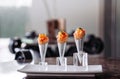 Fresh raw jouicy Salmon Tartare with tomato in mini waffle cones modern creative cuisine