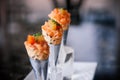 Fresh raw juicy Salmon Tartare with tomato in mini waffle cones modern creative cuisine