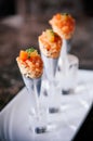 Fresh raw juicy Salmon Tartare with tomato in mini waffle cones modern creative cuisine