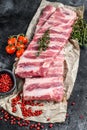 Fresh raw lamb spare ribs with spices and herbs. Black background. Top view Royalty Free Stock Photo