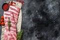 Fresh raw lamb spare ribs with spices and herbs. Black background. Top view. Copy space Royalty Free Stock Photo