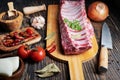 Fresh raw lamb spare ribs with spices and herbs on Black wooden table Royalty Free Stock Photo