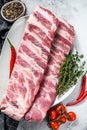 Fresh raw lamb spare ribs with spices and herbs. Gray background. Top view Royalty Free Stock Photo