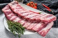 Fresh raw lamb spare ribs with spices and herbs. Gray background. Top view Royalty Free Stock Photo