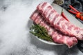 Fresh raw lamb spare ribs with spices and herbs. Gray background. Top view. Copy space Royalty Free Stock Photo