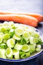 Fresh raw leek slice in a bowl with carrots. washed sliced ready-to-cook leeks Royalty Free Stock Photo