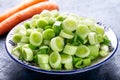 Fresh raw leek slice in a bowl with carrots. washed sliced ready-to-cook leeks Royalty Free Stock Photo