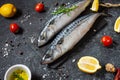 Fresh raw mackerel with lemon and spices on black stone background Royalty Free Stock Photo