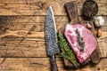Fresh Raw marble meat pork steaks on a cutting board with knife. wooden background. Top view. Copy space Royalty Free Stock Photo