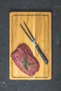 Fresh raw meat beef steak on wooden cutting board with thyme Royalty Free Stock Photo