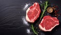 Fresh raw meat beef steaks on black wooden board, top down view, text copy space, two red meat steaks