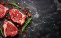 Fresh raw meat on black board top view, variety of beef steak, spices, herbs for cooking, grilling Royalty Free Stock Photo