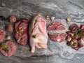 Fresh raw meat. Different types of raw pork meat, chicken, beef, turkey giblets with herbs on dark marble, copy space Royalty Free Stock Photo