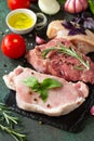 Fresh raw meat. Different types of raw pork meat, chicken fillet and beef with vegetables and herbs Royalty Free Stock Photo