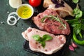 Fresh raw meat. Different types of raw pork meat, chicken fillet and beef with vegetables and herbs Royalty Free Stock Photo