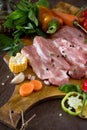 Fresh raw meat pork fillet with vegetables on the cutting board. Royalty Free Stock Photo