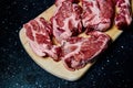 Fresh raw meat pork neck on wooden Board on black table