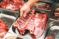 Fresh raw meat, pork ribs in supermarket. Butcher shop. Butcher`s hands holding pork spare ribs for sale. Butcher`s display Royalty Free Stock Photo