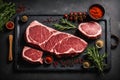 Fresh raw meat on slate black board top view, Variety of spices, seasoning for cooking, grilling. Generative AI Royalty Free Stock Photo