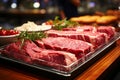 Fresh raw meat on slate board top view, beef steak, spices, seasoning for cooking, grilling, black angus prime Royalty Free Stock Photo