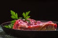 Fresh Raw Meat for Steak Ribeye, Decorated with Herbs and Sprinkled with Spices and Coarse Salt, Lies in a Cast-Iron Vintage Pan. Royalty Free Stock Photo