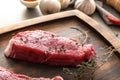 Fresh raw meat with thyme on wooden tray Royalty Free Stock Photo
