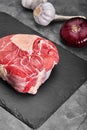 Fresh and raw meat. whole piece of steaks in a row ready to cook. Background black blackboard Royalty Free Stock Photo