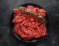 Fresh Raw mince, Minced beef, ground meat with herbs and spices on black plate Royalty Free Stock Photo