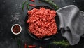 Fresh Raw mince, Minced beef, ground meat with herbs and spices on black plate Royalty Free Stock Photo