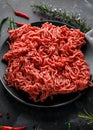 Fresh Raw mince, Minced beef, ground meat with herbs and spices on black plate Royalty Free Stock Photo
