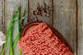 Fresh raw minced beef ground beef on old wood background and vegetables