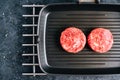 Fresh raw minced beef steak for burgers on black grill pan Royalty Free Stock Photo