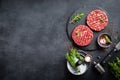 Fresh raw minced beef steak burgers with spices Royalty Free Stock Photo