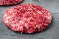 Fresh raw minced homemade farmers beef burgers cutlets, on gray stone background Royalty Free Stock Photo